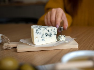 front-view-woman-cutting-cheese